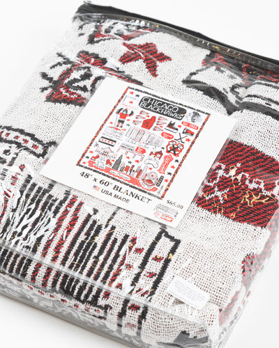 Julia Gash blanket with Chicago and Chicago Blackhawks inspired all over design - detail lay flat with packaging