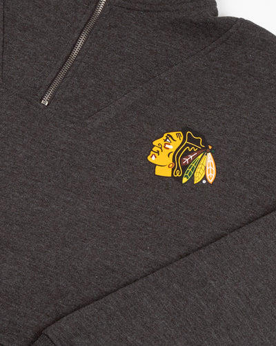 black chicka-d ladies quarter zip with Chicago Blackhawks primary logo printed on left chest - detail lay flat