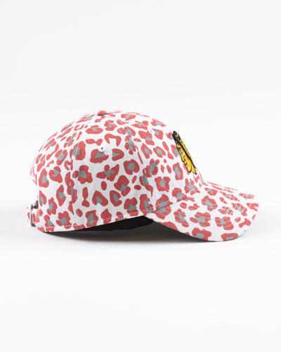 white New Era women's cap with all over pink cheetah print and Chicago Blackhawks primary logo on front - right side lay flat