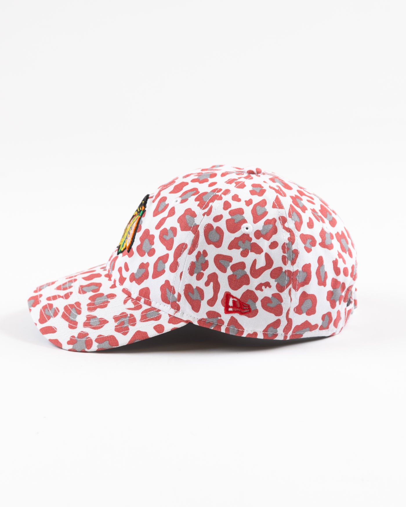 white New Era women's cap with all over pink cheetah print and Chicago Blackhawks primary logo on front - left side lay flat