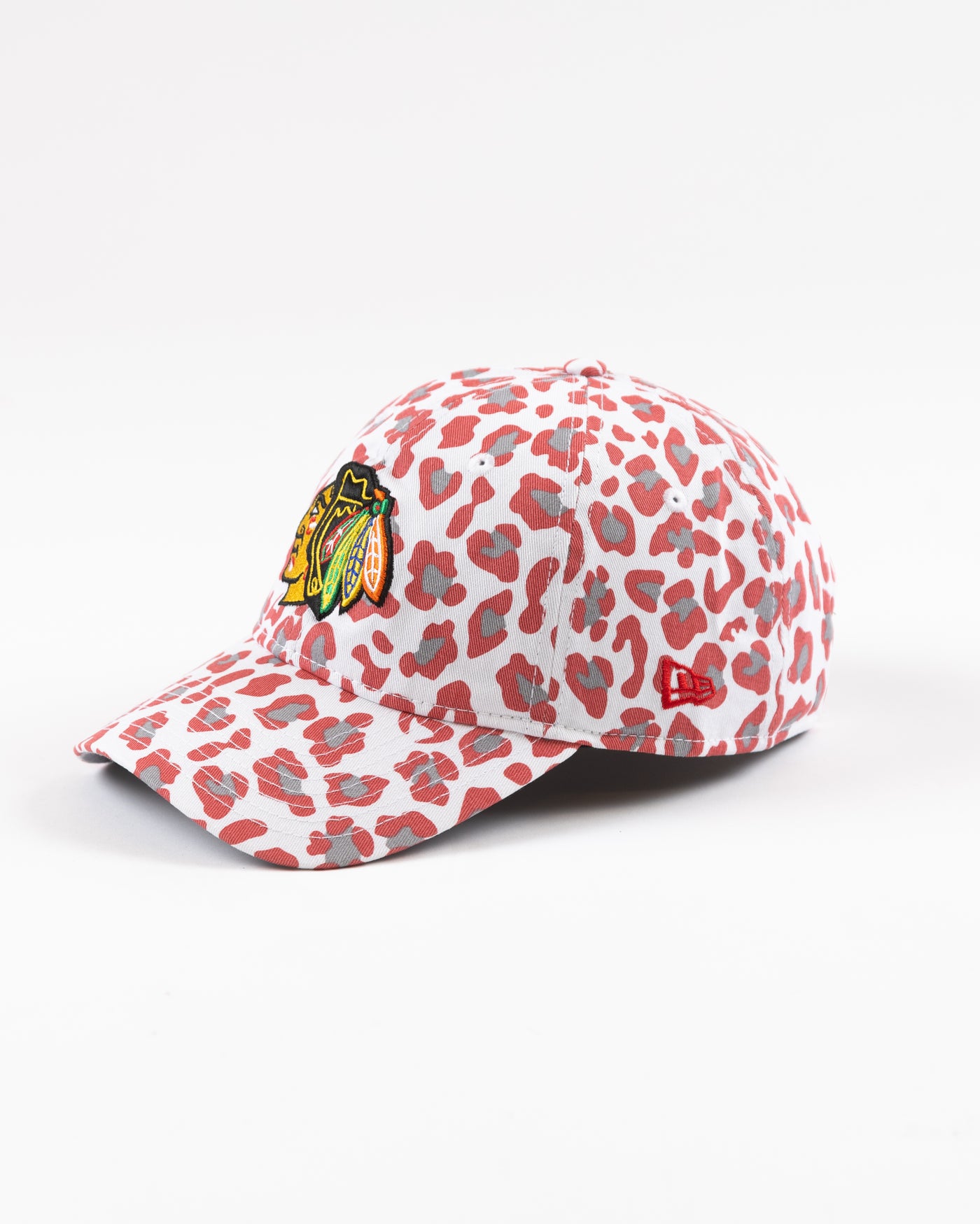 white New Era women's cap with all over pink cheetah print and Chicago Blackhawks primary logo on front - left angle lay flat