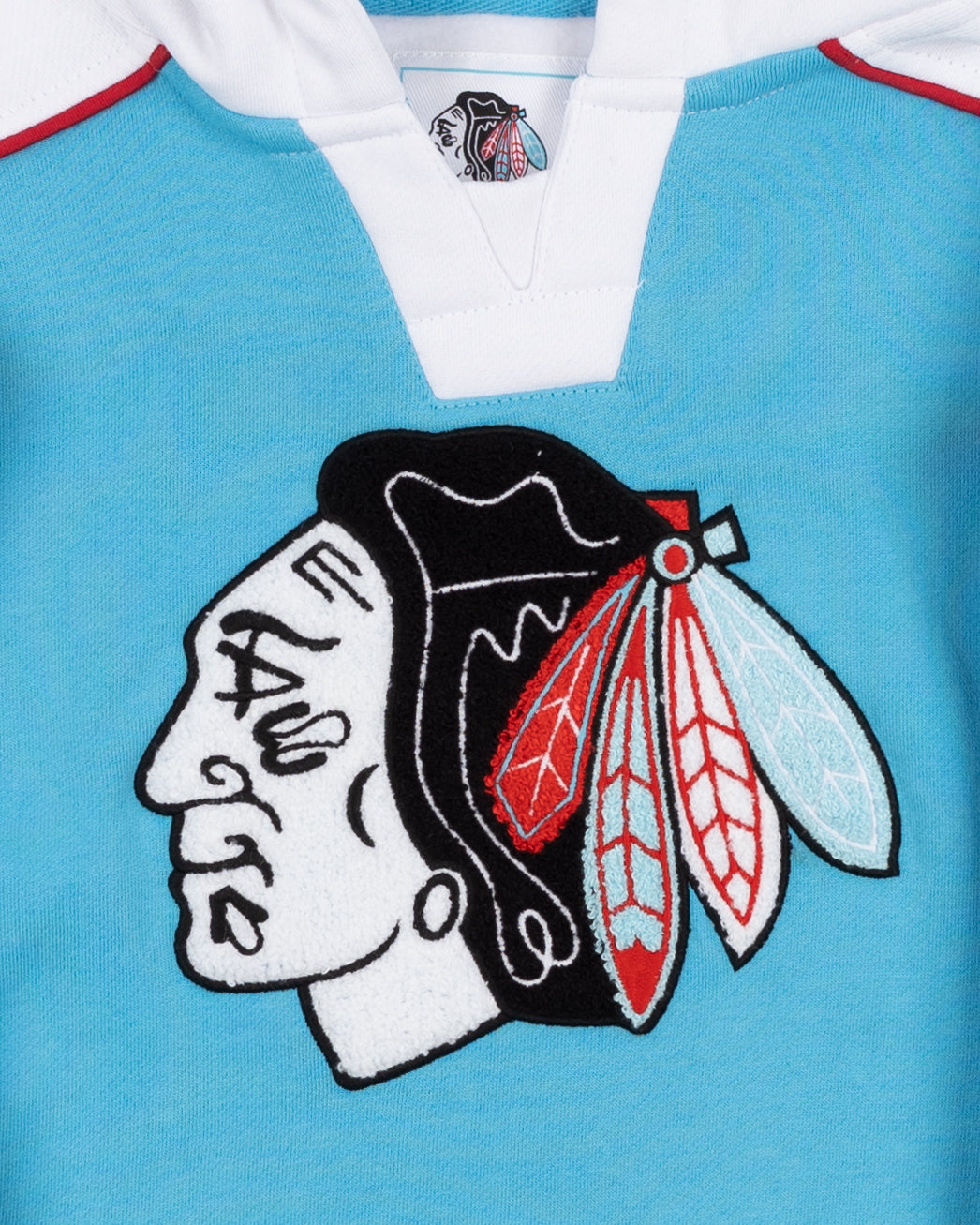 youth blue and white hockey jersey-inspired hoodie with Chicago Blackhawks primary logo on front and secondary logo on shoulders and no lace - front detail lay flat