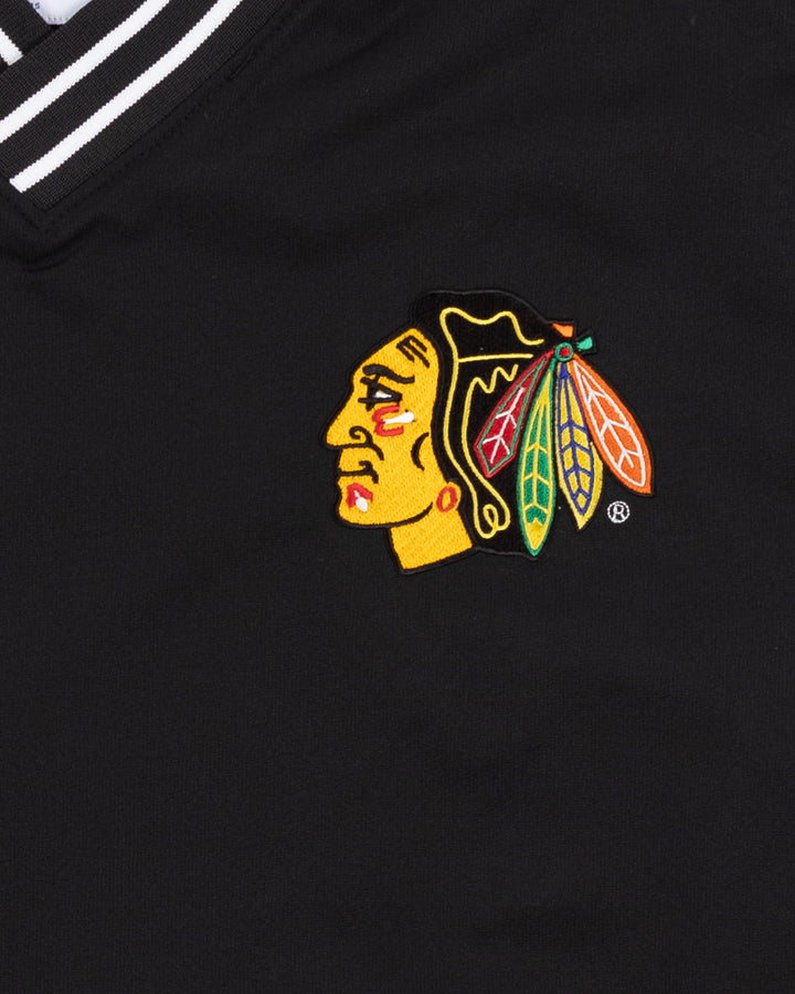 black Champion pullover sweater with Chicago Blackhawks primary logo on left chest and Blackhawks wordmark on back - front detail lay flat