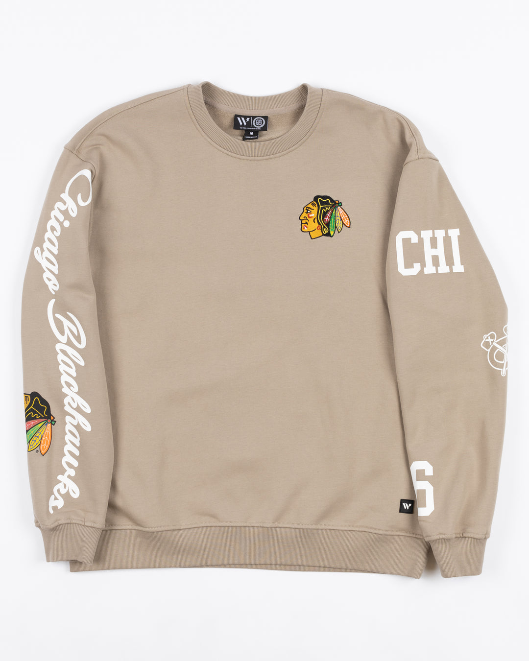 warm grey beige crewneck Wild Collective sweater with Chicago Blackhawks primary logo on left chest and script and primary logo on right sleeve - front lay flat