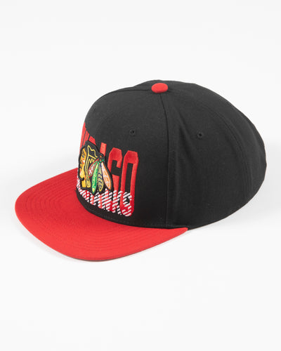 Mitchell & Ness Chicago Blackhawks snapback with red brim and primary logo with cross check wordmark embroidered on front panel - left angle lay flat
