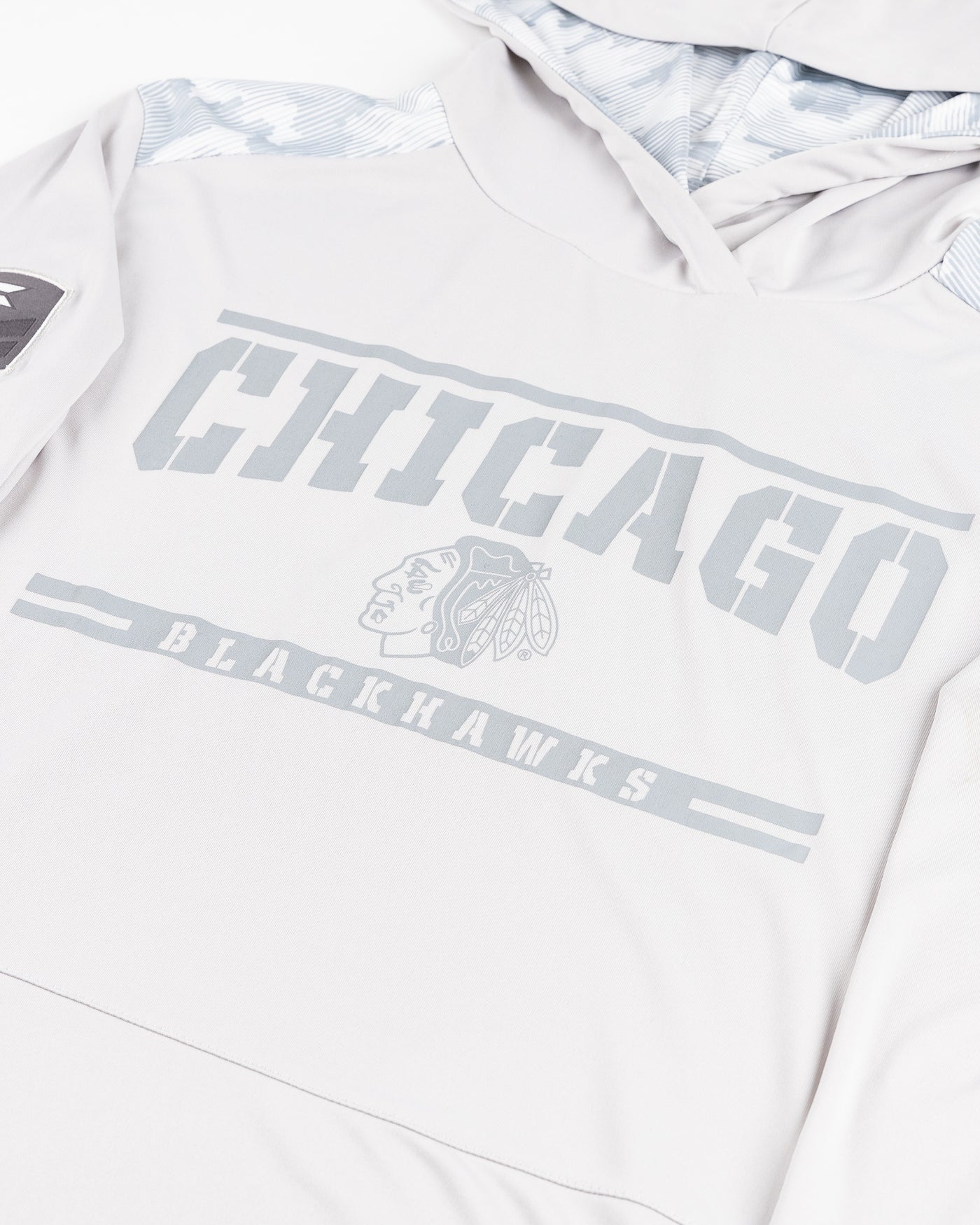 grey Colosseum operation hat trick long sleeve with hood with Chicago Blackhawks primary logo and wordmark graphic and patches on sleeves - detail  lay flat