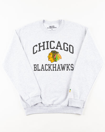 grey Chicago Blackhawks crewneck with wordmark and primary logo on chest and secondary logo on left wrist - front lay flat