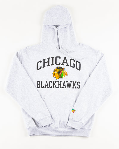 grey Chicago Blackhawks hoodie with wordmark and primary logo on chest and secondary logo on left wrist - front lay flat