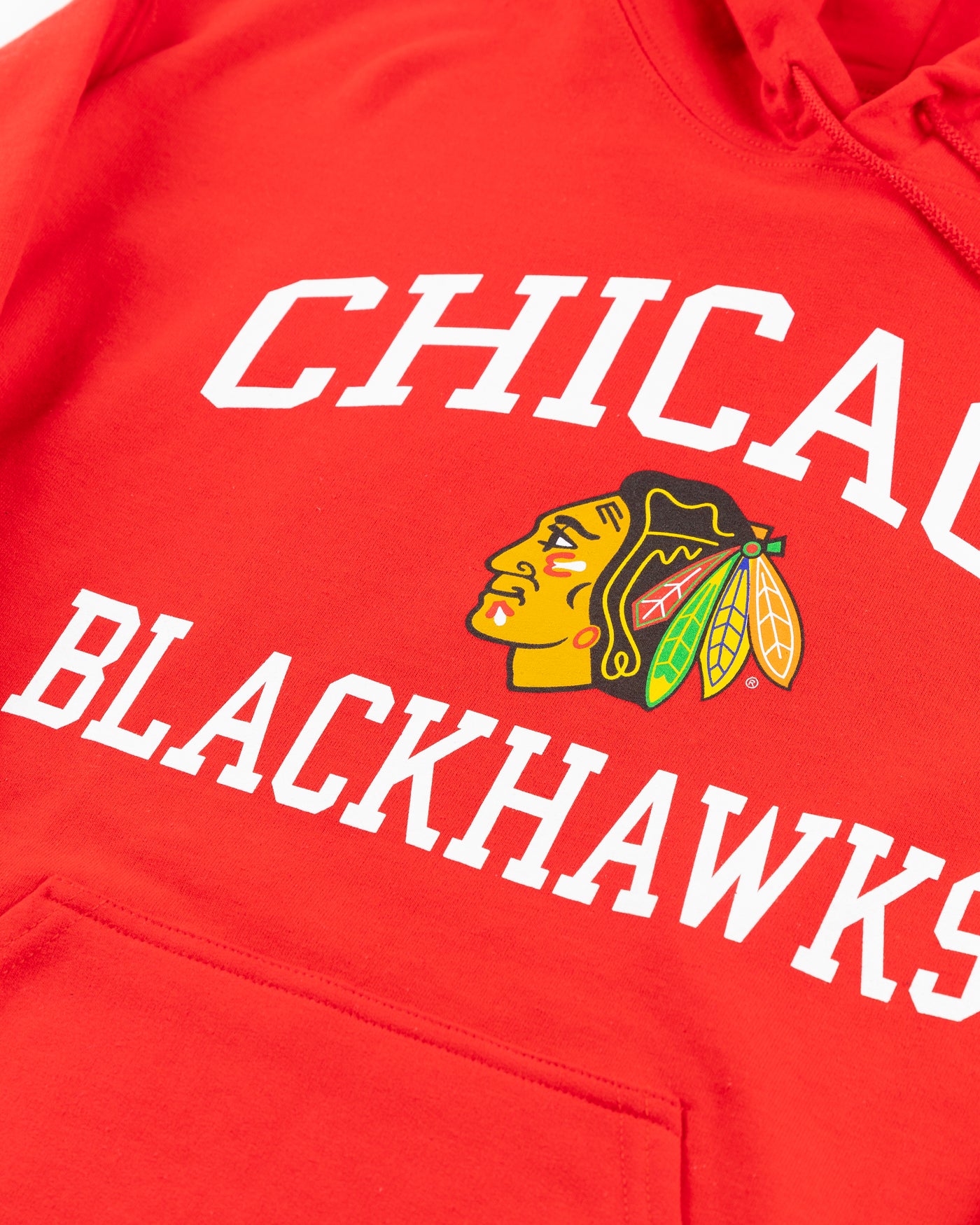 red Chicago Blackhawks hoodie with wordmark and primary logo on chest and secondary logo on left wrist - detail front lay flat