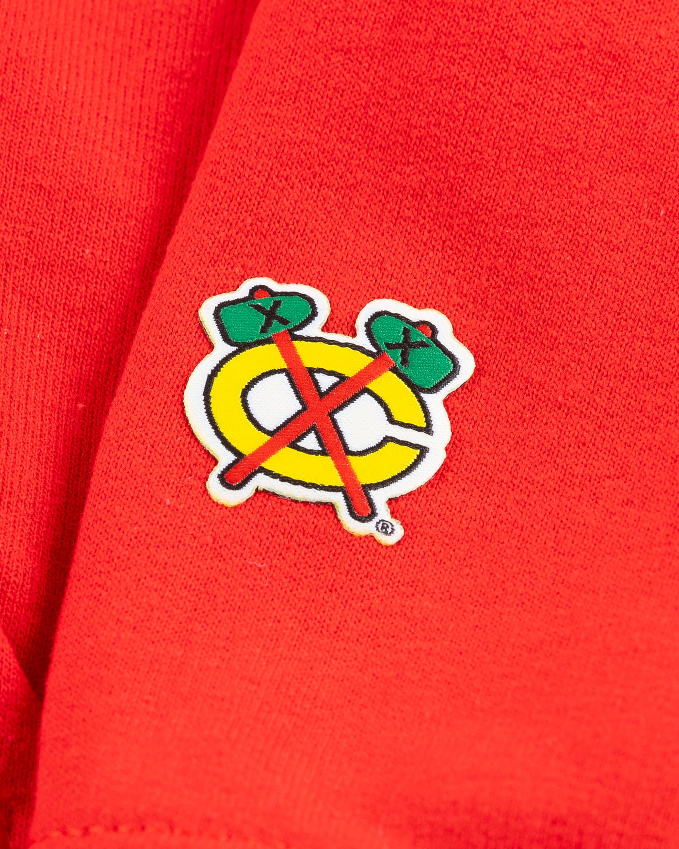 red Chicago Blackhawks hoodie with wordmark and primary logo on chest and secondary logo on left wrist - detail wrist lay flat
