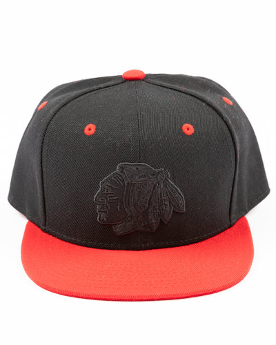 two tone black and red youth snapback cap with Chicago Blackhawks tonal primary logo on front and red wordmark on back - front lay flat