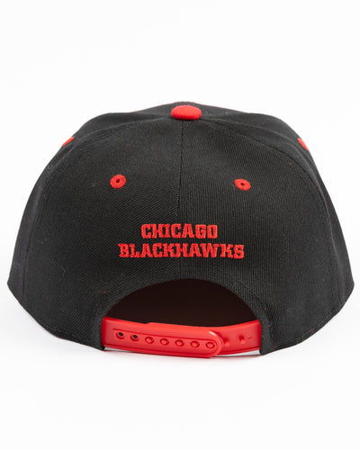 two tone black and red youth snapback cap with Chicago Blackhawks tonal primary logo on front and red wordmark on back - back lay flat