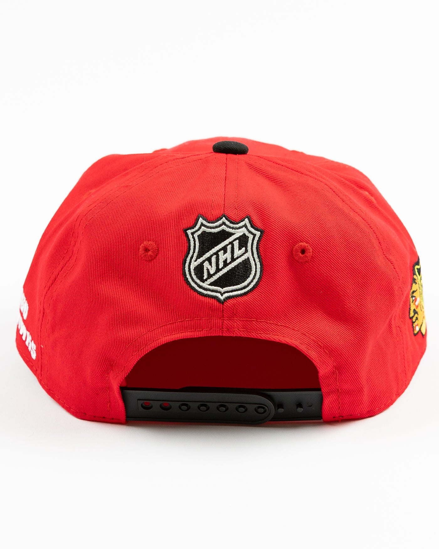 two tone red and black youth snapback cap with Chicago Blackhawks wordmark and primary logo across front - back lay flat