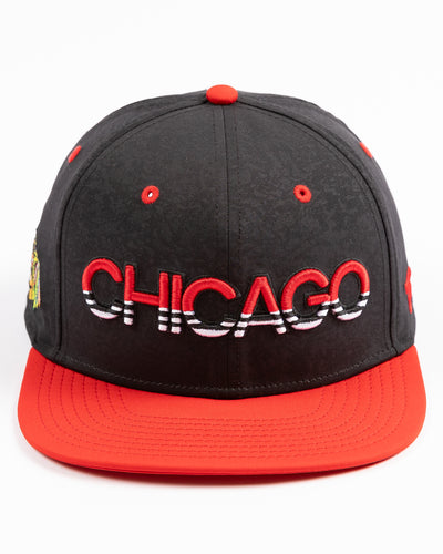 two tone black and red debossed Fanatics snapback cap with Chicago wordmark on front and Chicago Blackhawks primary logo embroidered on right side - front lay flat
