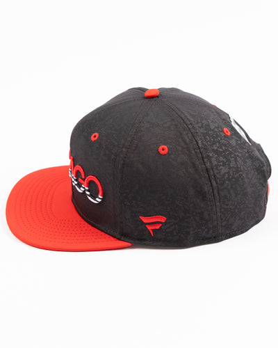 two tone black and red debossed Fanatics snapback cap with Chicago wordmark on front and Chicago Blackhawks primary logo embroidered on right side - left side lay flat