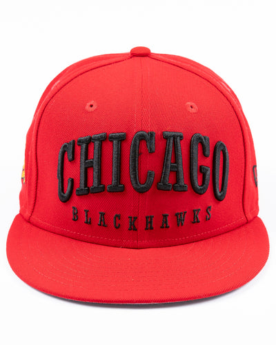 red New Era 59FIFTY fitted cap with Chicago Blackhawks wordmark embroidered on front, primary logo on right side and secondary logo on back - front lay flat