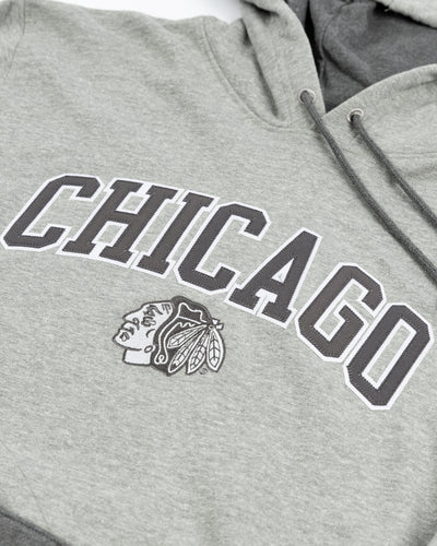 grey striped Champion hoodie with embroidered Chicago and Chicago Blackhawks primary logo on front - detail lay flat