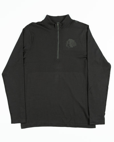 black lululemon half zip jacket with tonal Chicago Blackhawks primary logo printed on left chest - front lay flat