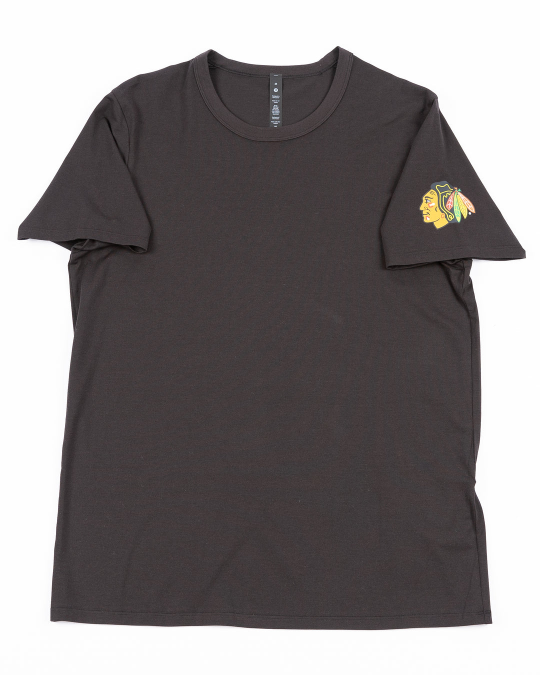 black lululemon tee with Chicago Blackhawks primary logo printed on left shoulder - front lay flat