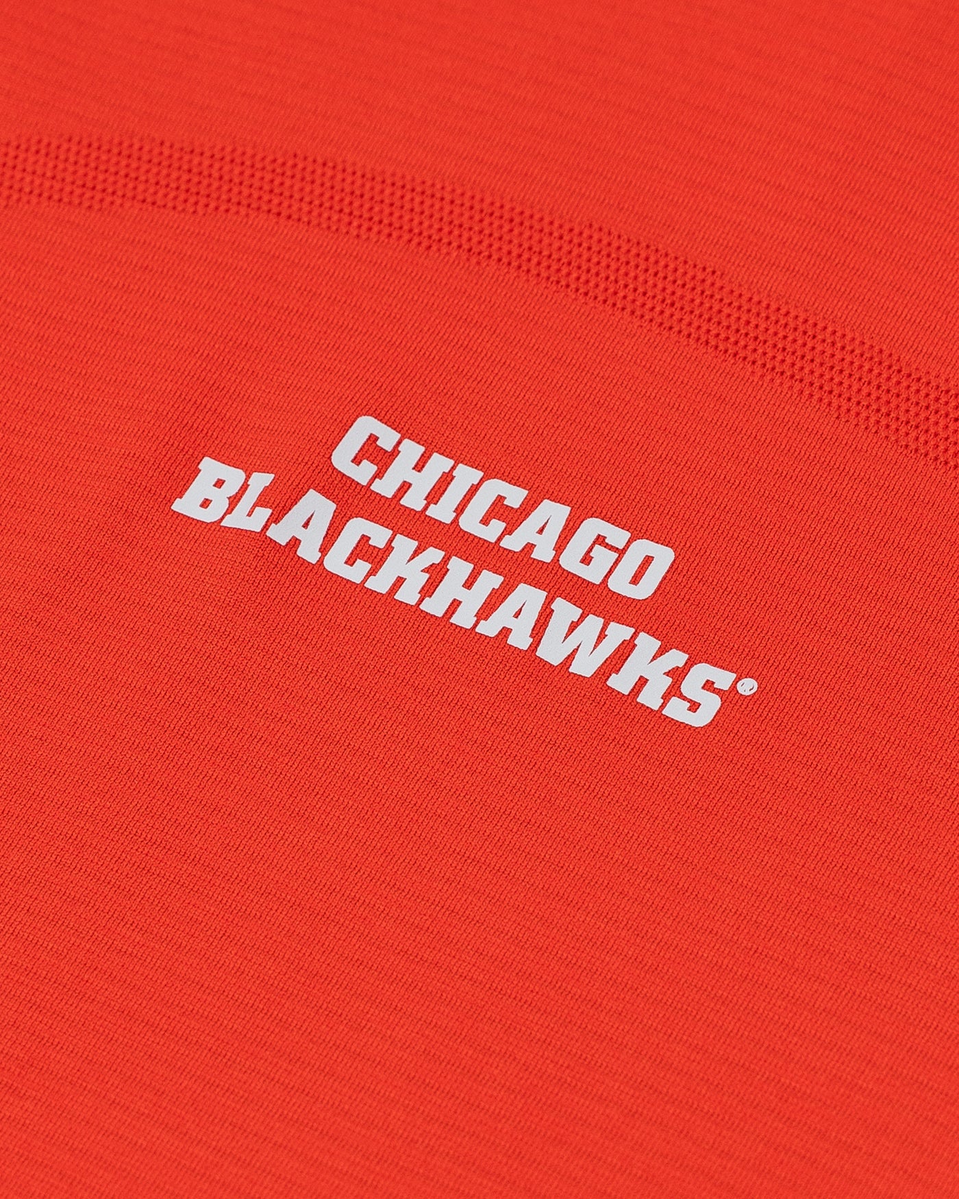 red lululemon ladies long sleeve tee with Chicago Blackhawks wordmark on chest - detail lay flat