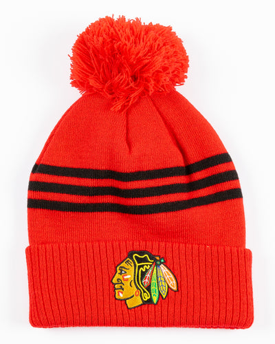 red adidas knit hat with pom with Chicago Blackhawks primary logo embroidered on cuff - front lay flat