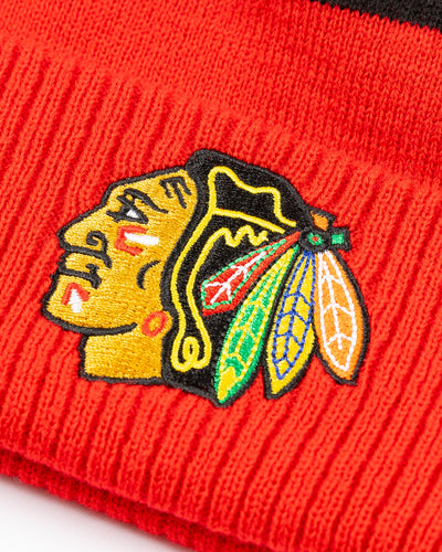 red adidas knit hat with pom with Chicago Blackhawks primary logo embroidered on cuff - detail lay flat