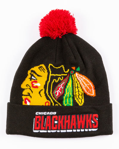 black youth Mitchell & Ness knit hat with Chicago Blackhawks primary logo on front and embroidered wordmark on cuff and red pom - front lay flat