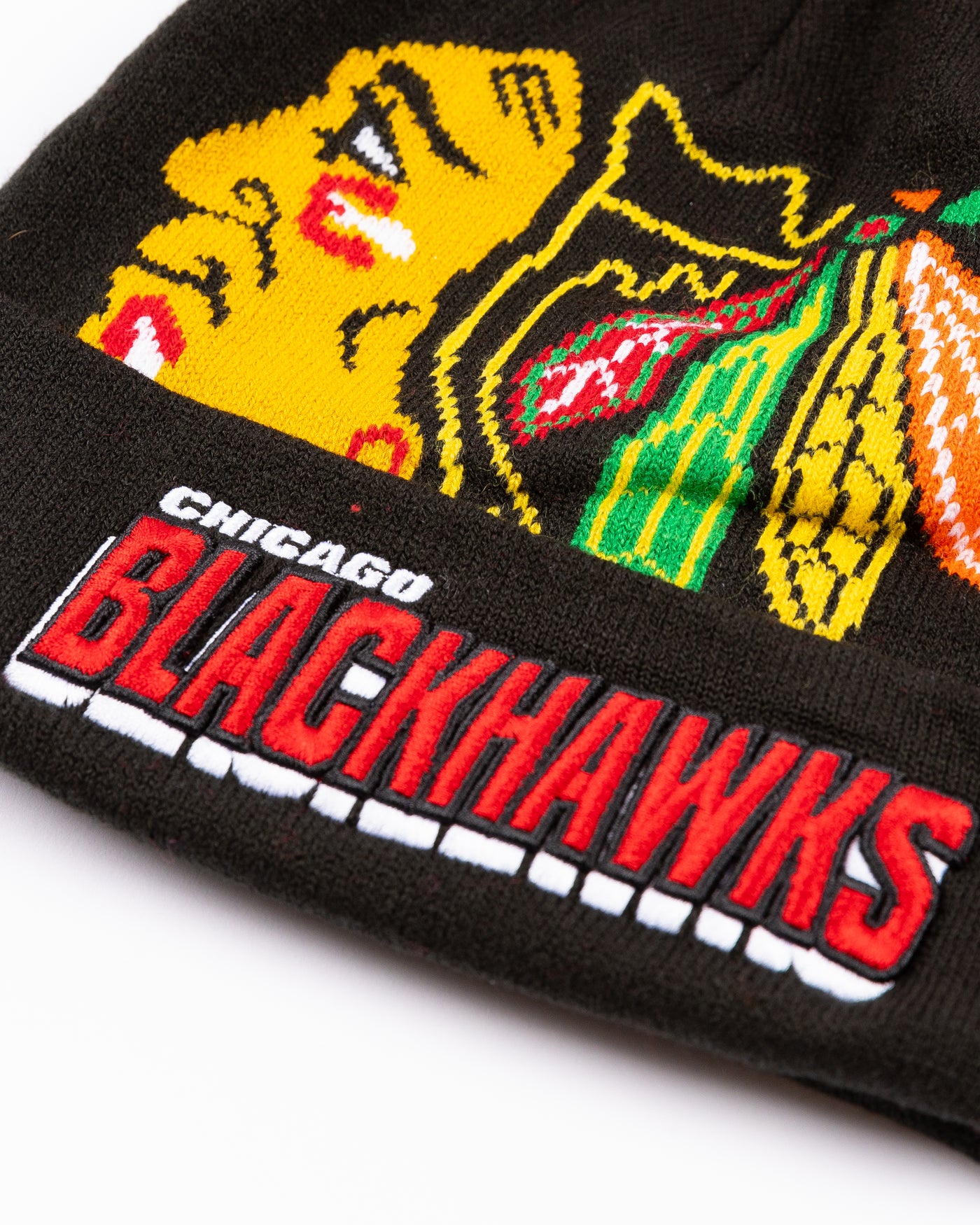 black youth Mitchell & Ness knit hat with Chicago Blackhawks primary logo on front and embroidered wordmark on cuff and red pom - detail lay flat