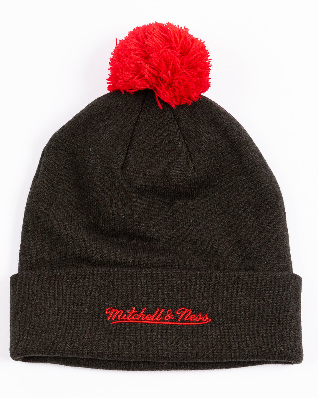 black youth Mitchell & Ness knit hat with Chicago Blackhawks primary logo on front and embroidered wordmark on cuff and red pom - back lay flat