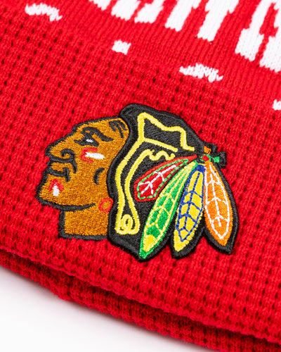 red youth knit beanie with Chicago Blackhawks graphic across front and embroidered primary logo on waffle knit cuff and black pom on top - detail lay flat