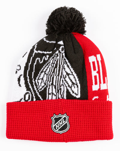 red youth knit beanie with Chicago Blackhawks graphic across front and embroidered primary logo on waffle knit cuff and black pom on top - back lay flat