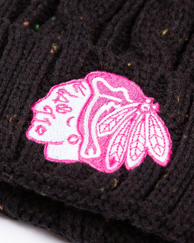 black youth knit beanie with pom with Chicago Blackhawks tonal pink primary logo embroidered on front - detail lay flat