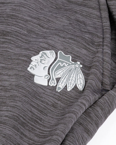grey Fanatics Authentic Pro jogger sweatpants with tonal Chicago Blackhawks primary logo on left pocket - detail lay flat