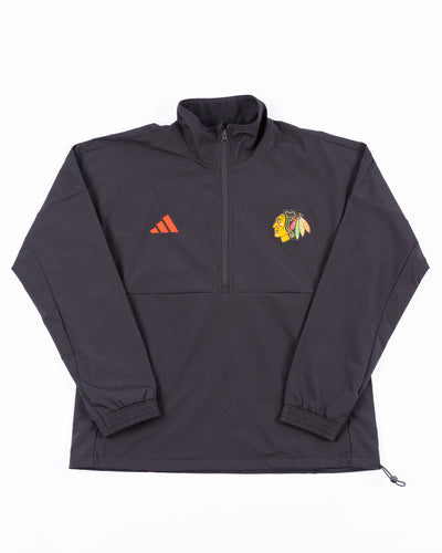 black ladies adidas jacket with half zip and Chicago Blackhawks primary logo on left chest - front lay flat