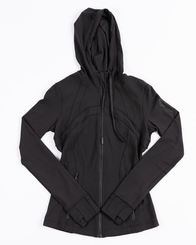black lululemon hooded jacket with tonal Chicago Blackhawks logo printed on left shoulder - front lay flat