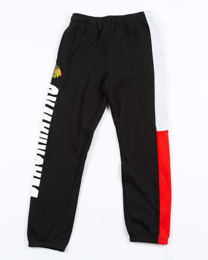 color blocked youth jogger with Chicago Blackhawks wordmark and primary logo on left leg - back lay flat