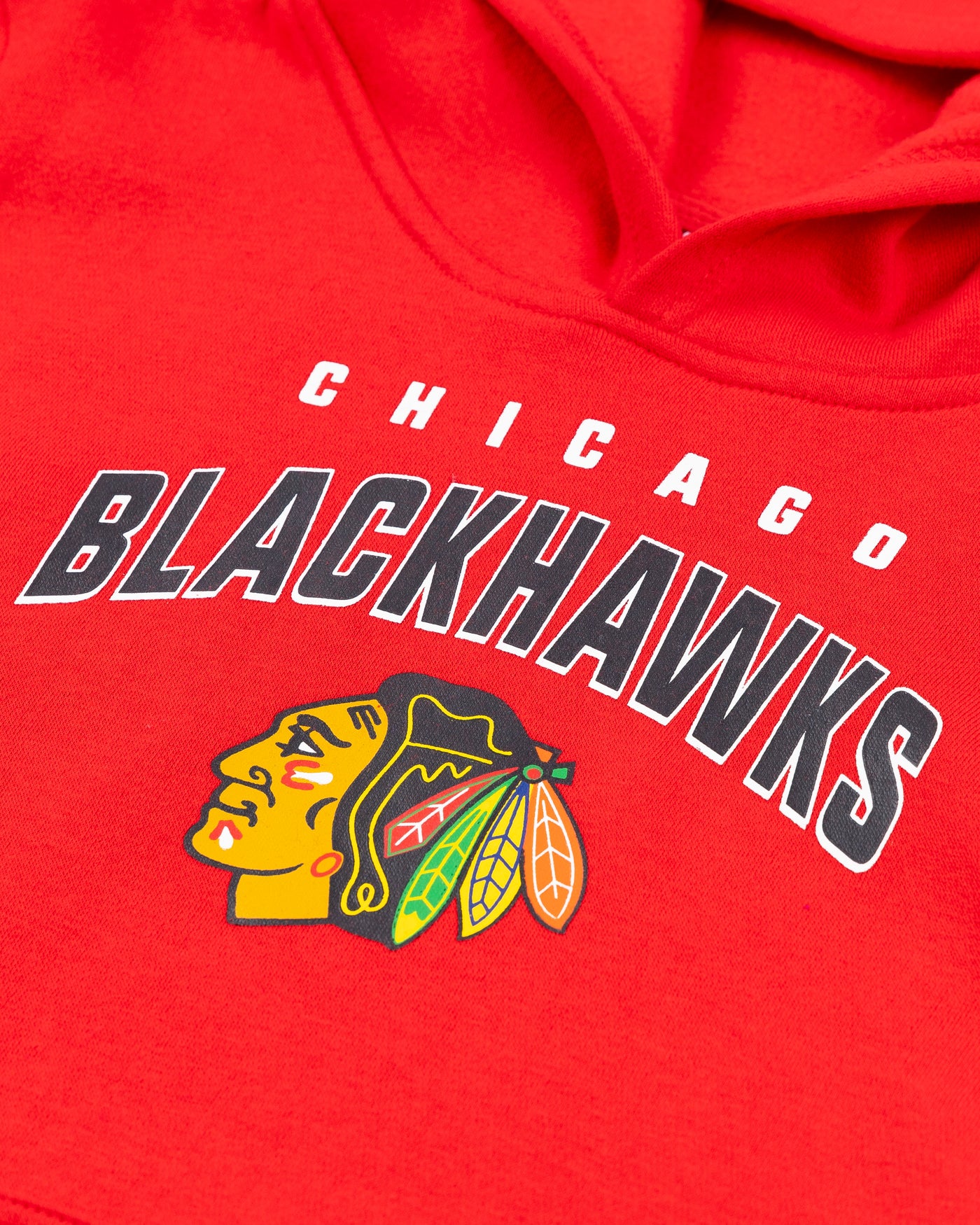 red youth Chicago Blackhawks hoodie with wordmark and primary logo - detail lay flat