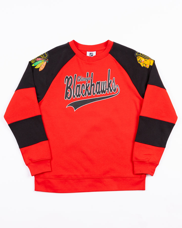 red and black youth crewneck with Chicago Blackhawks wordmark across front and primary logo on both shoulders - front lay flat