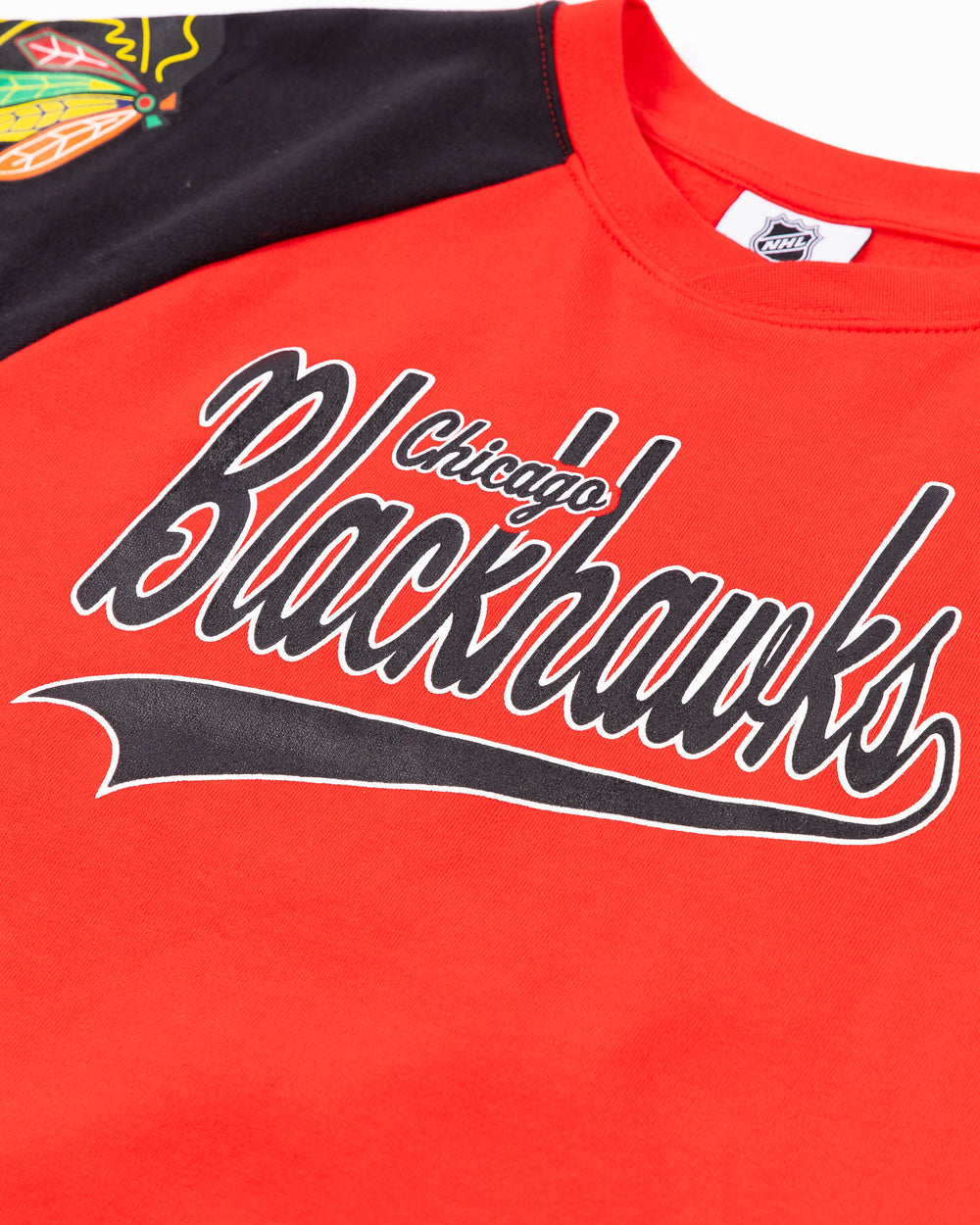 red and black youth crewneck with Chicago Blackhawks wordmark across front and primary logo on both shoulders - detail lay flat