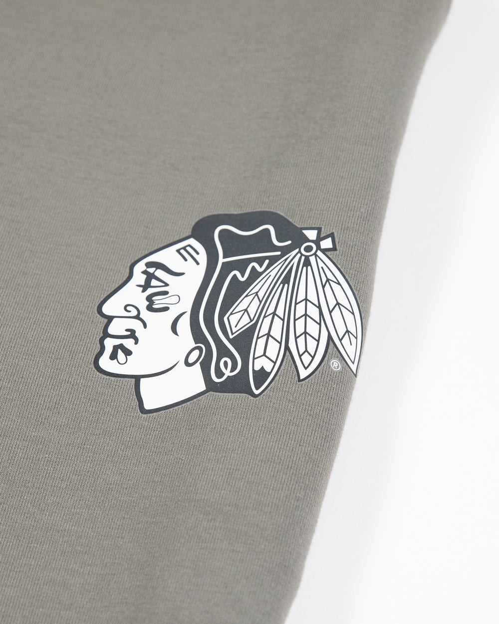 sage green lululemon sweatpant joggers with black and white Chicago Blackhawks primary logo on left thigh - detail lay flat