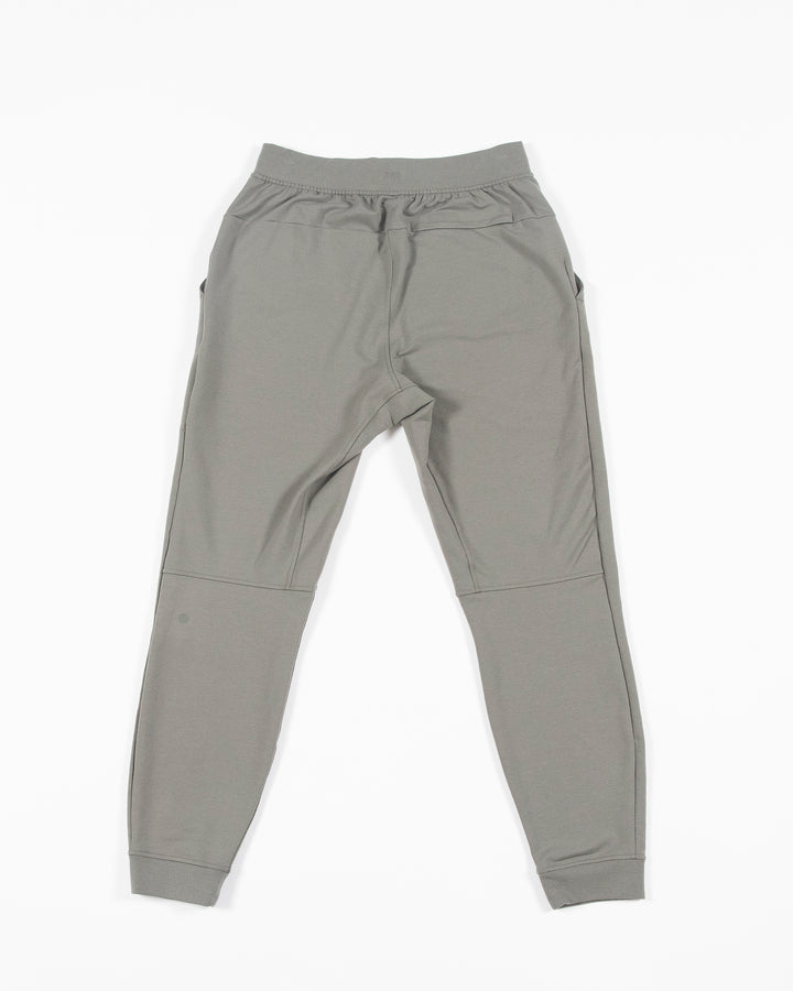 sage green lululemon sweatpant joggers with black and white Chicago Blackhawks primary logo on left thigh - back lay flat
