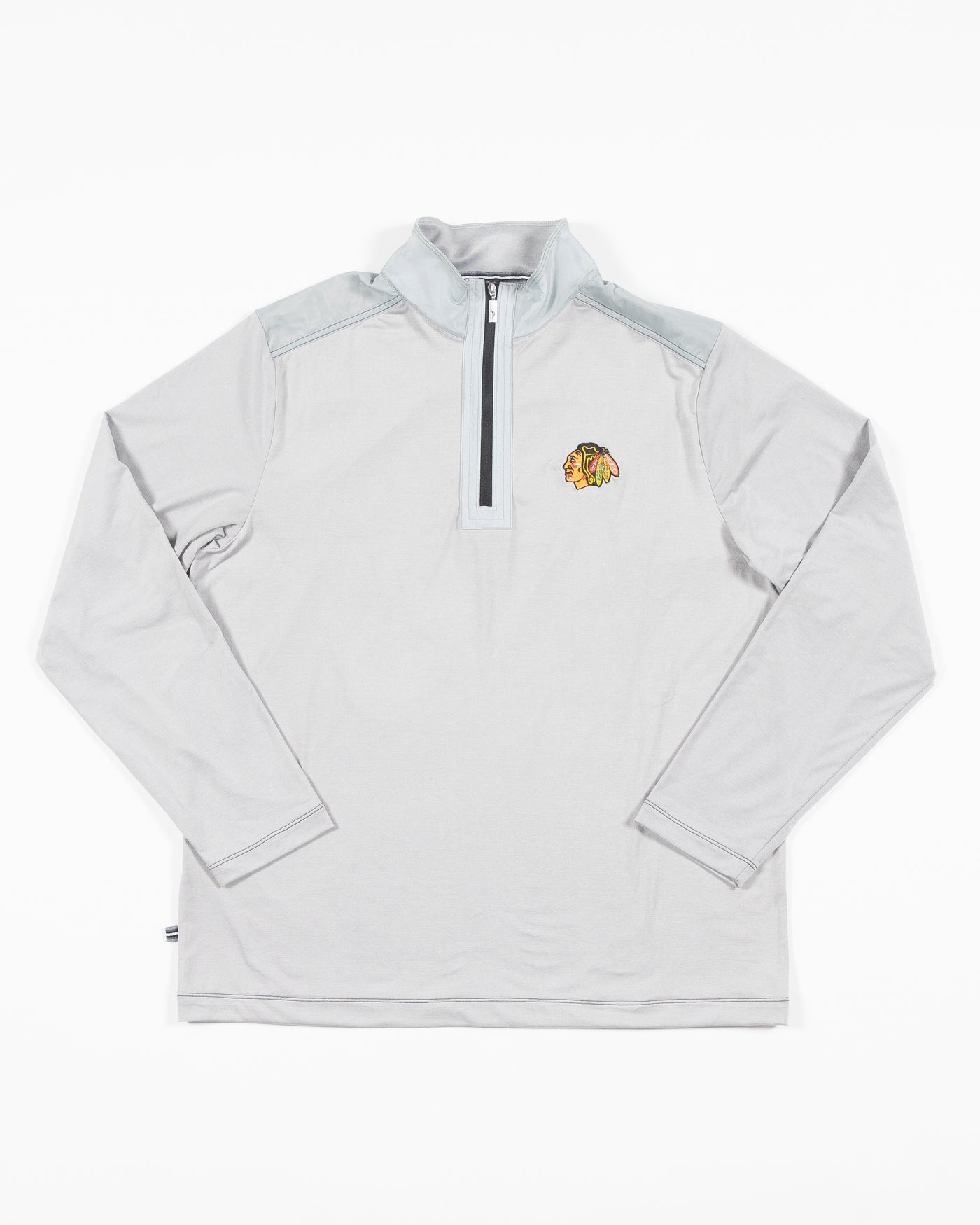 grey Tommy Bahama half zip jacket with Chicago Blackhawks primary logo embroidered on left chest - front lay flat