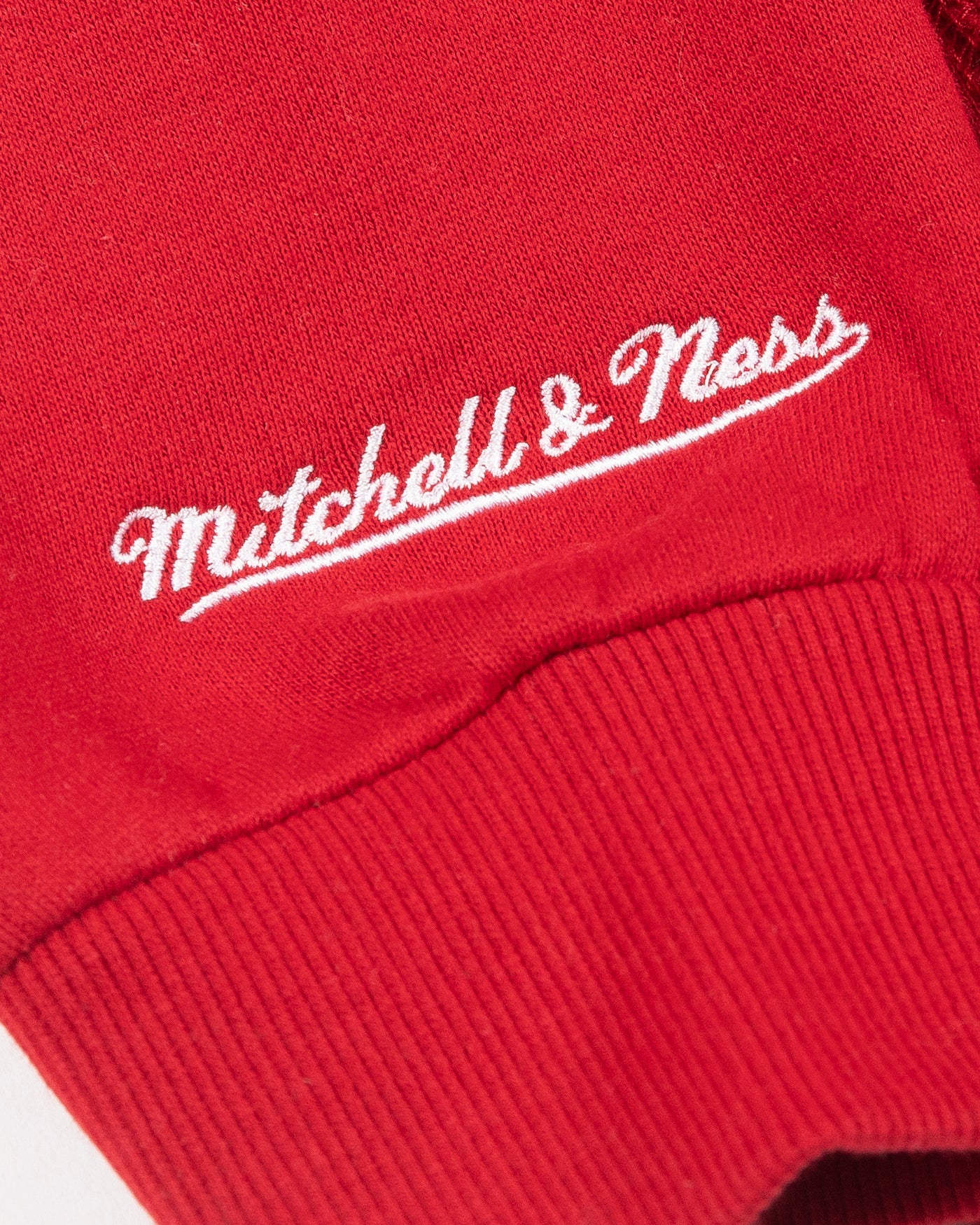 red Mitchell & Ness hoodie with Chicago Blackhawks secondary logo on front, NHL Western Conference patch on left shoulder and Chicago Blackhawks wordmark on hood - detail logo lay flat