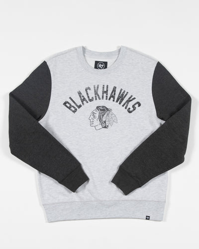 grey '47 brand crewneck sweatshirt with dark grey contrasting sleeves and vintage Blackhawks wordmark and primary logo graphic across chest - front lay flat 