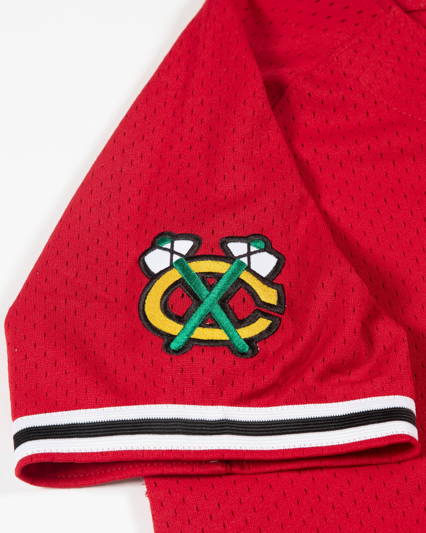 red Mitchell & Ness baseball inspired jersey with Chicago Blackhawks primary logo on left chest and secondary logo on right shoulder - detail secondary logo lay flat