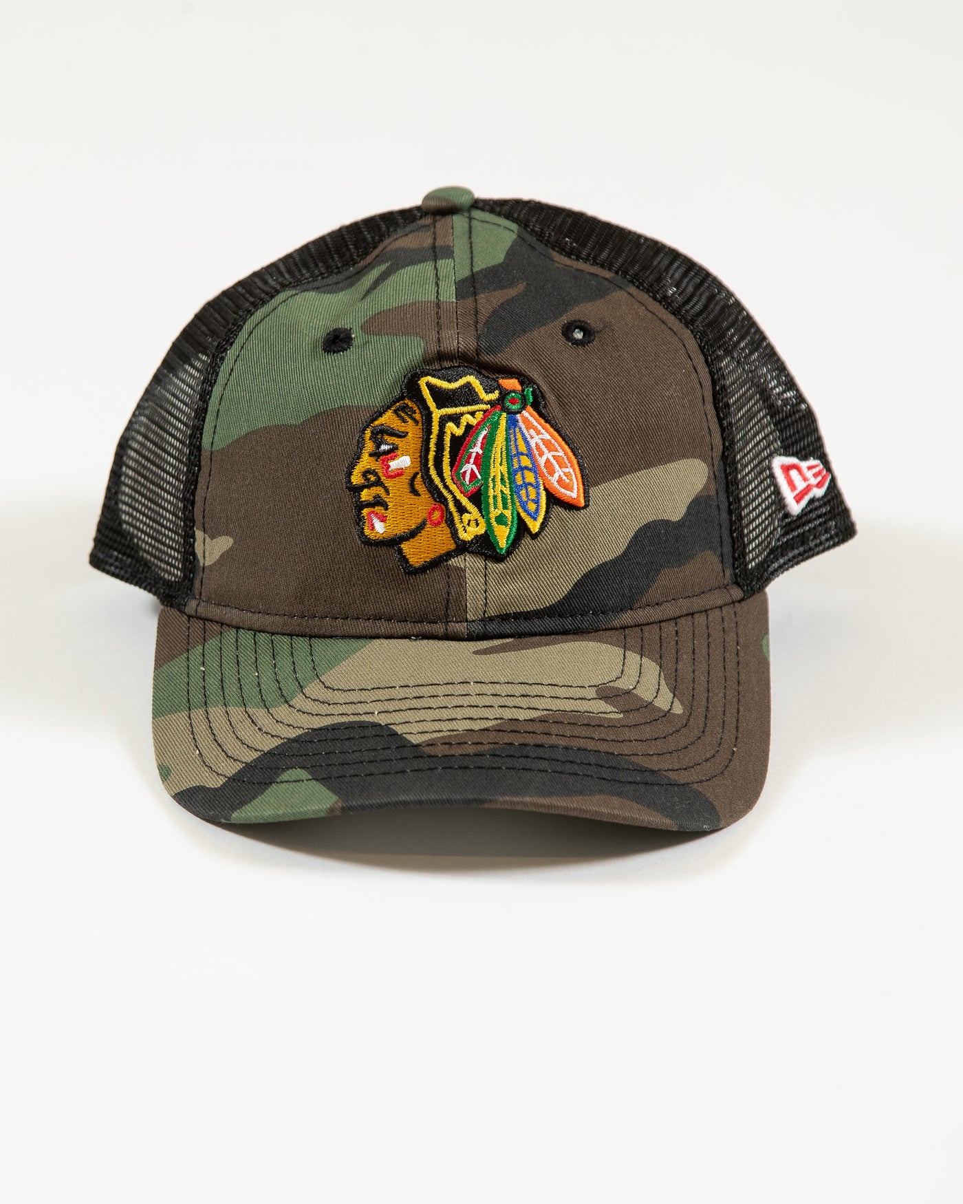 camo New Era youth trucker snapback with Chicago Blackhawks primary logo embroidered on front - front lay flat