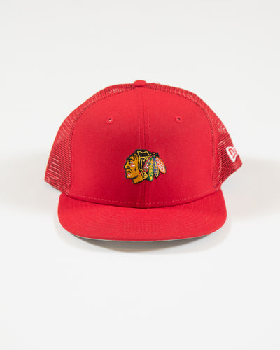 red youth New Era trucker cap with Chicago Blackhawks primary logo embroidered on front - front angle lay flat