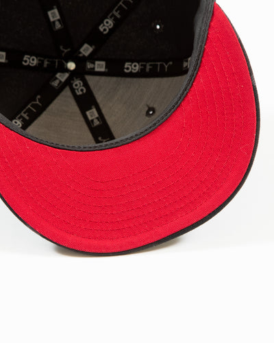 red New Era trucker hat with Chicago Blackhawks primary logo embroidered on front - under brim