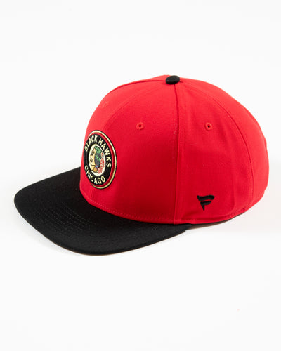Red and black Fanatics snapback with vintage Chicago Blackhawks logo embroidered on front and original six patch embroidered on right side - left angle lay flat