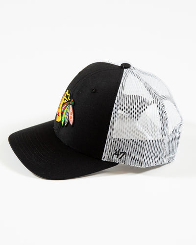 black and white '47 brand trucker cap with adjustable snapback closure and Chicago Blackhawks primary logo embroidered on front - left side angle lay flat